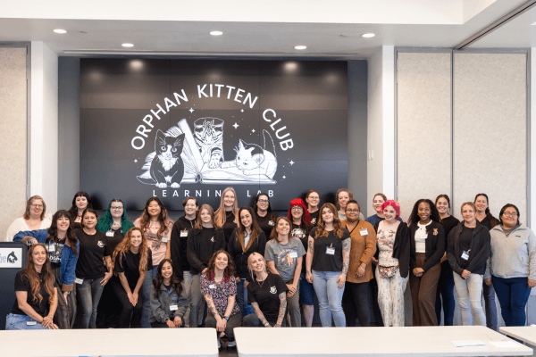 Group of people with Orphan Kitten Club logo